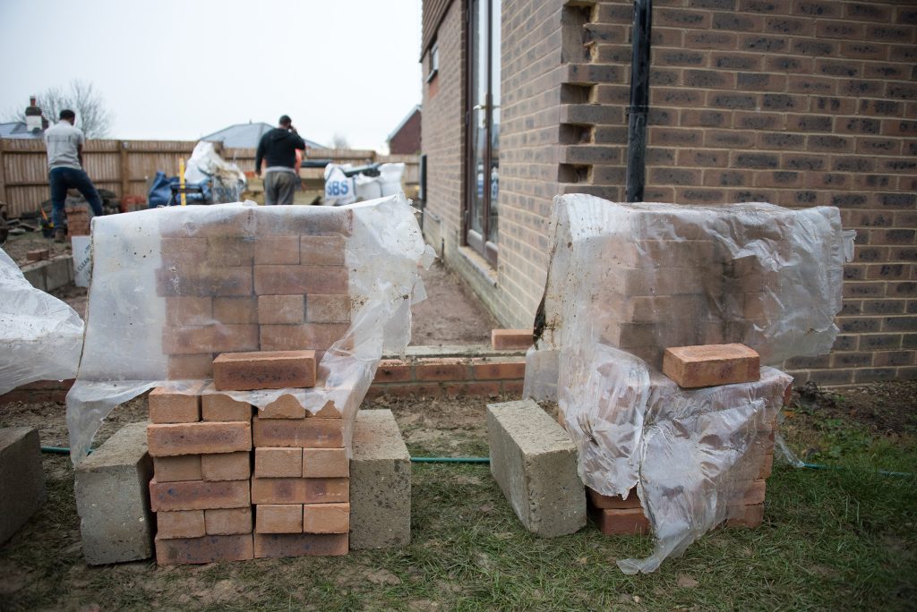 The ground floor of the side extension is to be clad in matching brick, with larch cladding above