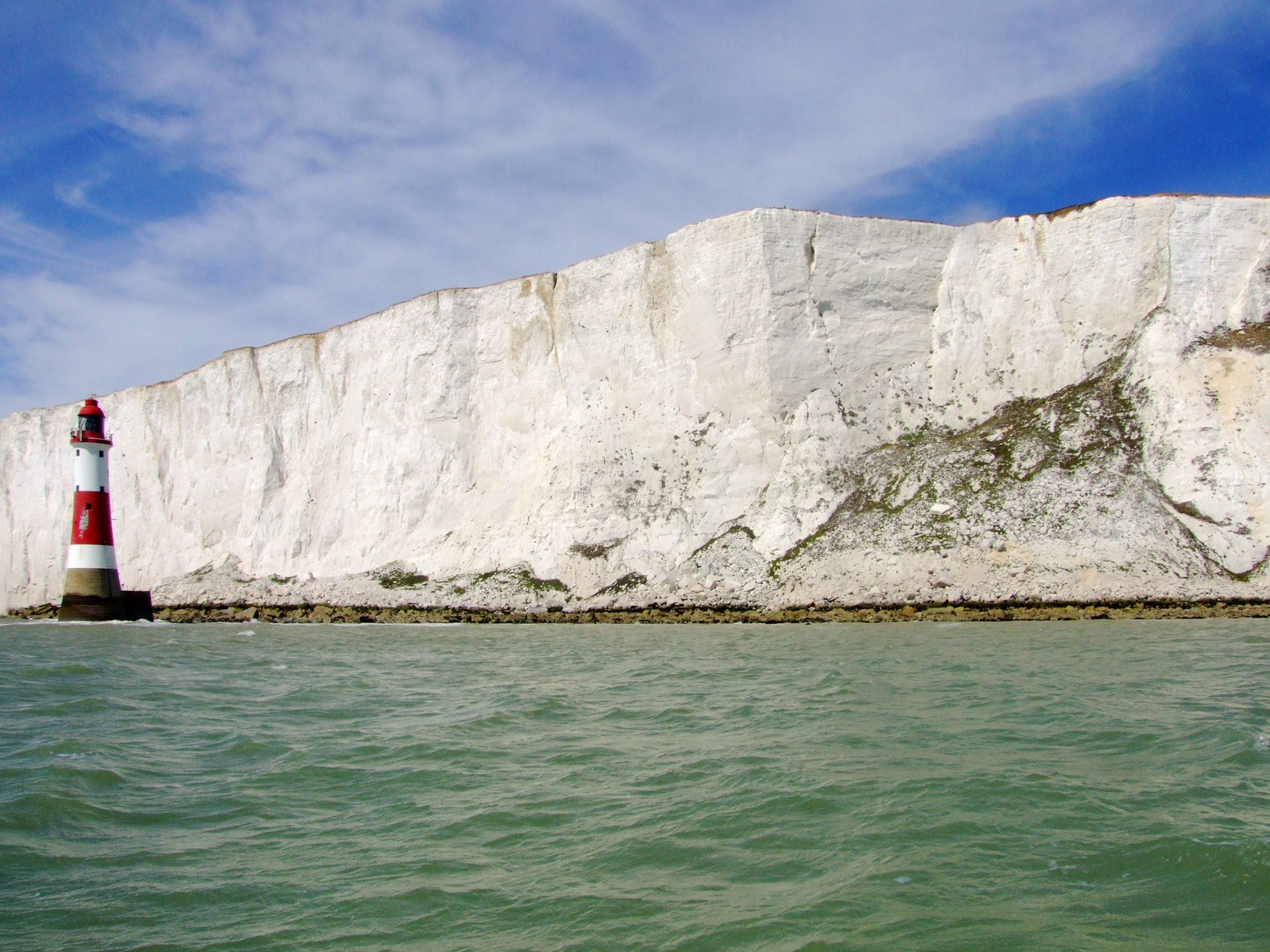 The South Downs chalk formation at Beachy Head. This same geology lies beneath every building site in the region - excavation reveals potential structure, not waste.