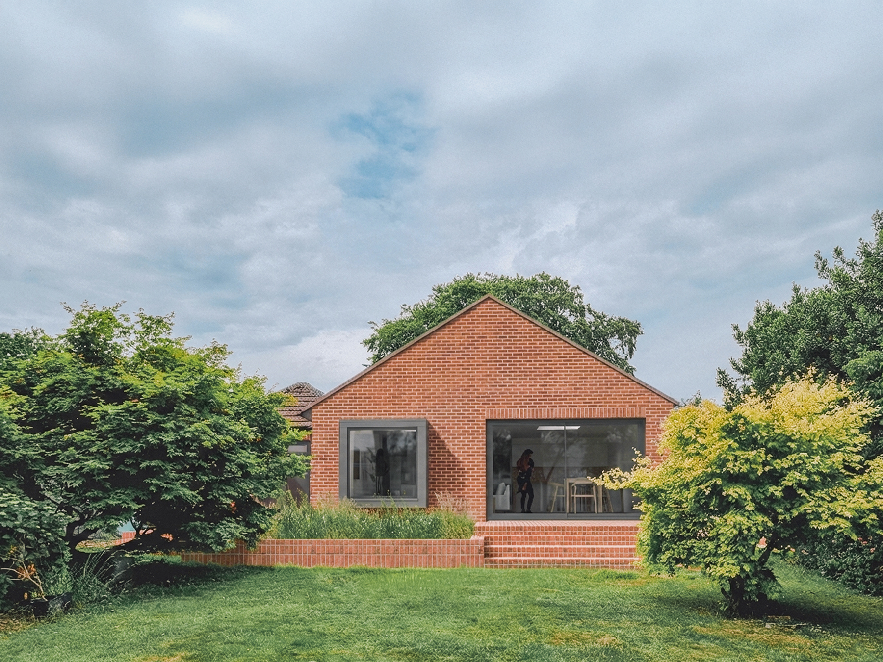 A 3d render of the revised planning application, showing the brick-clad gable end of the extension