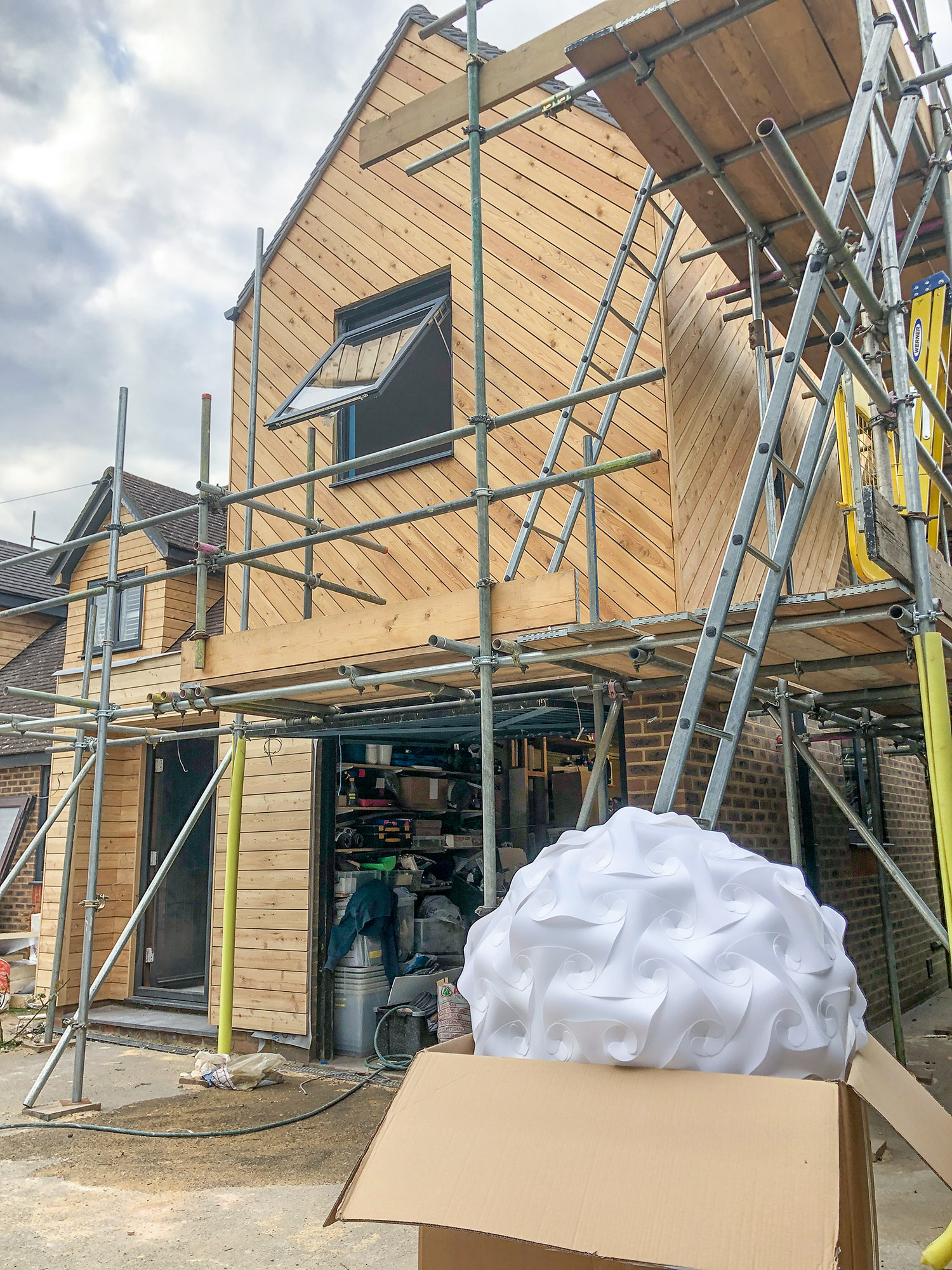 Timber-clad extension under construction at Pembury, Kent, showing cedar cladding and scaffolding at Stage 5